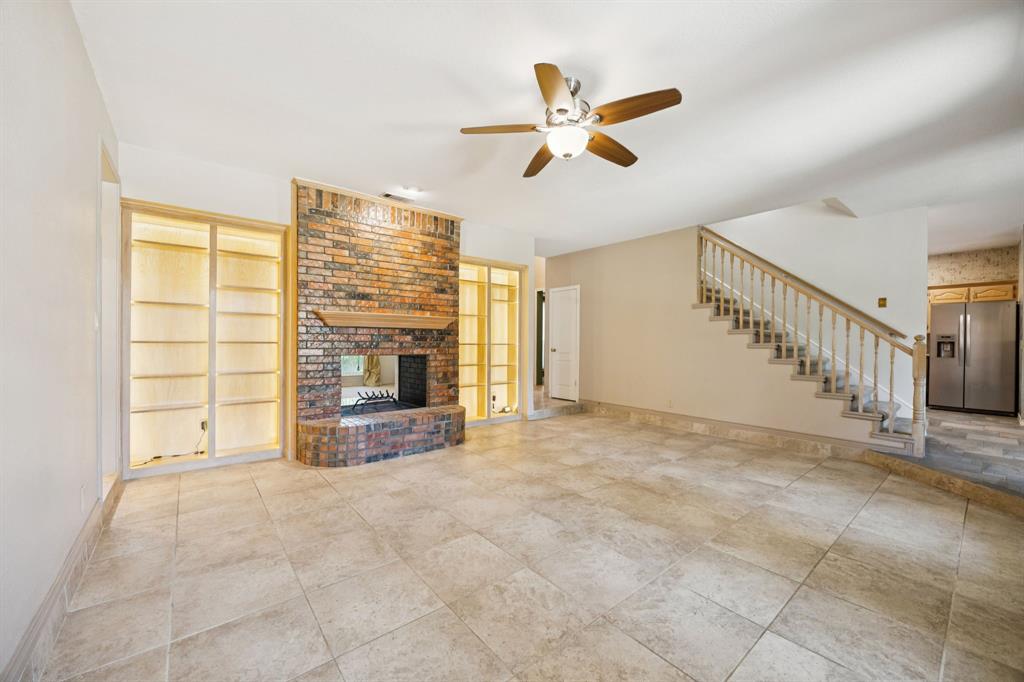 2604 Spring Lake Drive Richardson, TX 75082 - Photo 10 of 34 a view of an empty room with a fireplace and a window