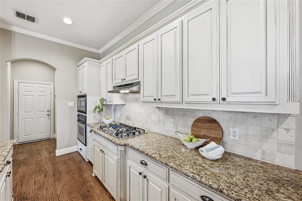 3200 Walnut Grove Place Flower Mound, TX 75022 - Photo 11 of 33 a kitchen with granite countertop white cabinets and a sink