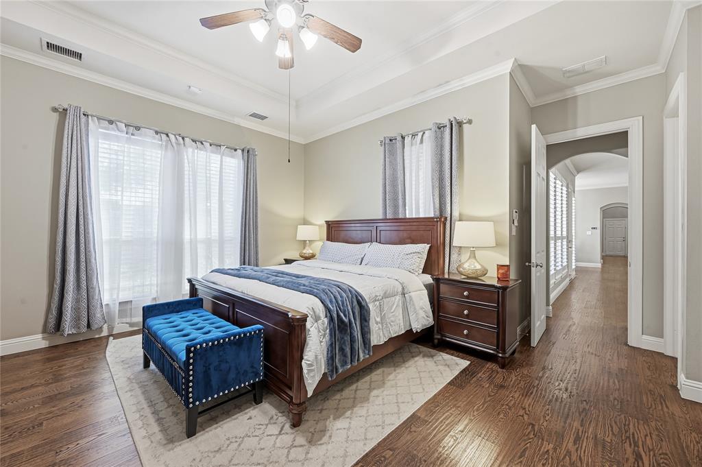 3200 Walnut Grove Place Flower Mound, TX 75022 - Photo 15 of 33 a bedroom with a large bed and a chandelier