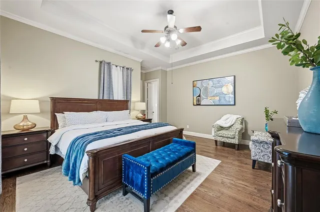 a spacious bedroom with a bed and a chandelier