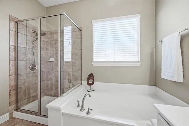 a white bath tub sitting next to a shower