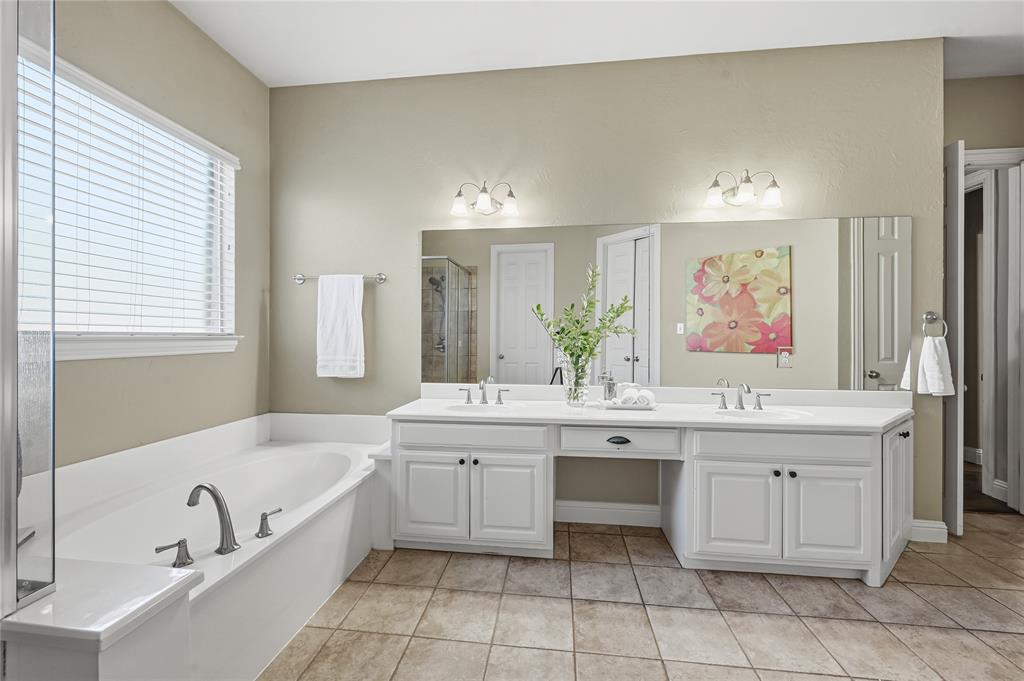3200 Walnut Grove Place Flower Mound, TX 75022 - Photo 19 of 33 a bathroom with a tub sink and mirror