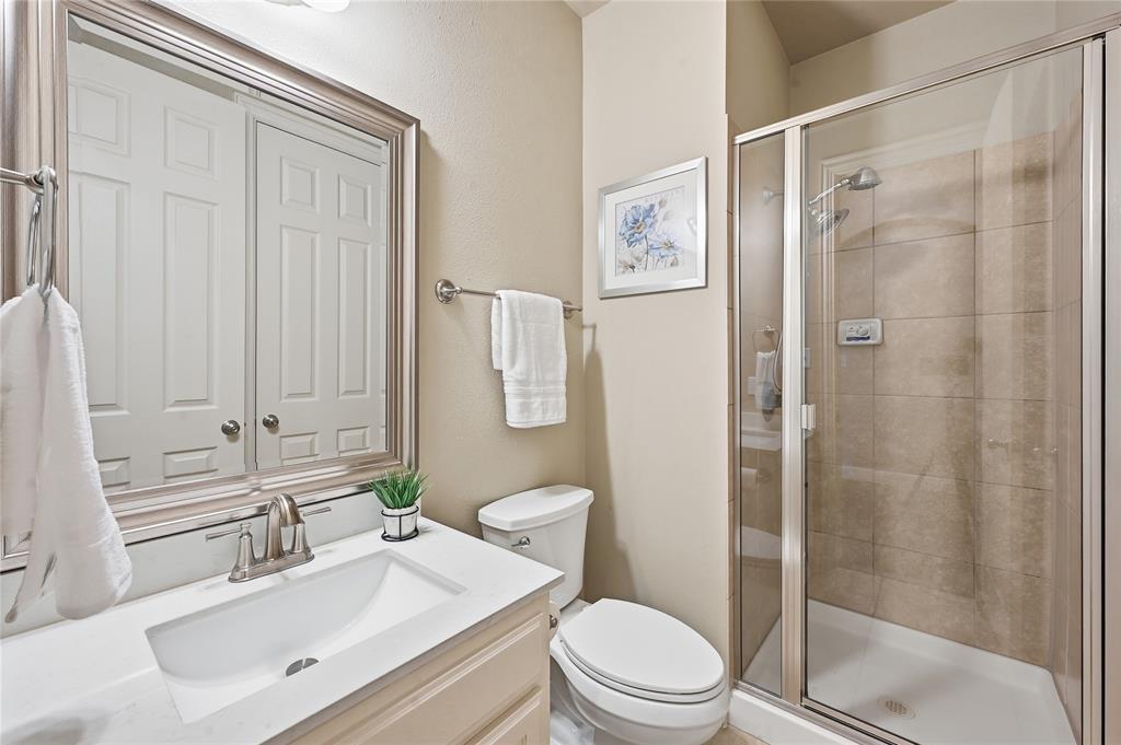 3200 Walnut Grove Place Flower Mound, TX 75022 - Photo 21 of 33 a bathroom with a sink a toilet and shower