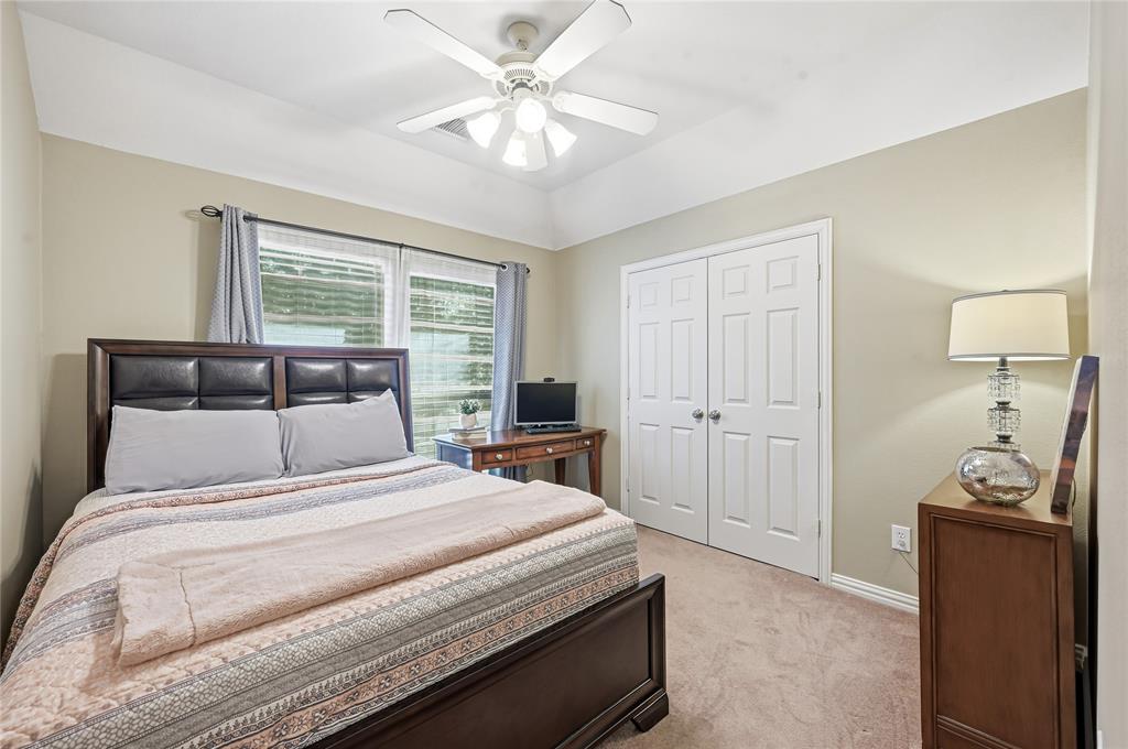 3200 Walnut Grove Place Flower Mound, TX 75022 - Photo 27 of 33 a bedroom with a bed and a chandelier