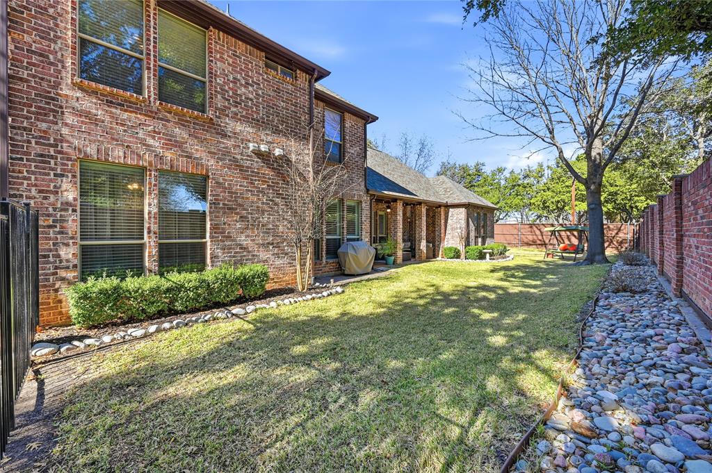 3200 Walnut Grove Place Flower Mound, TX 75022 - Photo 30 of 33 a brick house with a big yard plants and large tree
