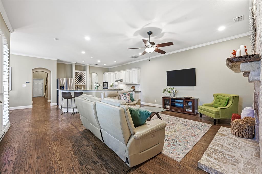 3200 Walnut Grove Place Flower Mound, TX 75022 - Photo 6 of 33 a living room with furniture a flat screen tv and kitchen view