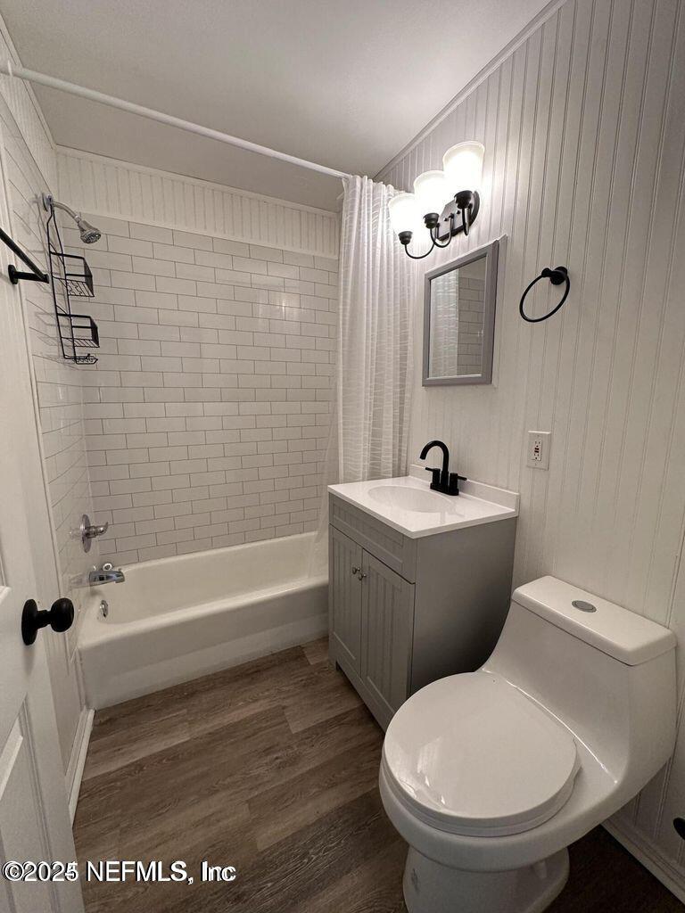 803 Crestwood Street Jacksonville, FL 32208 - Photo 11 of 14 a bathroom with a toilet a sink and bathtub