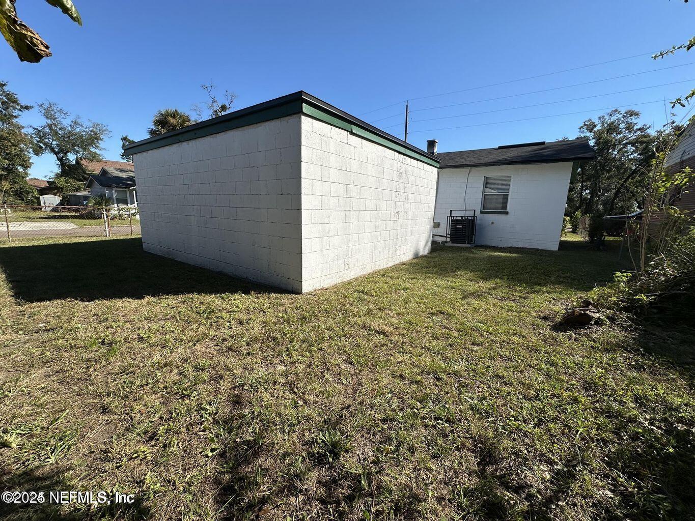 803 Crestwood Street Jacksonville, FL 32208 - Photo 12 of 14 a view of a house with a yard