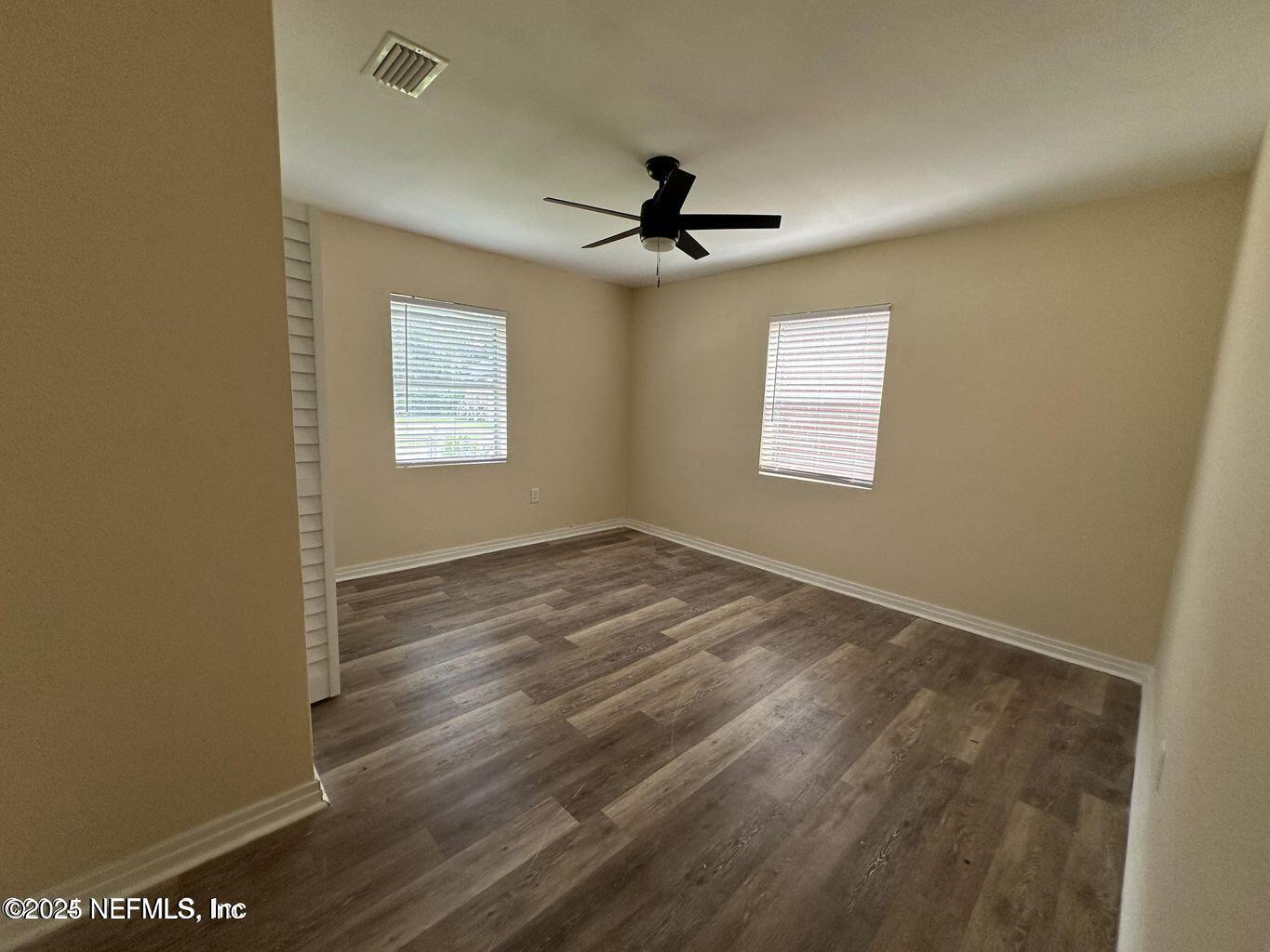 803 Crestwood Street Jacksonville, FL 32208 - Photo 9 of 14 an empty room with windows and fan