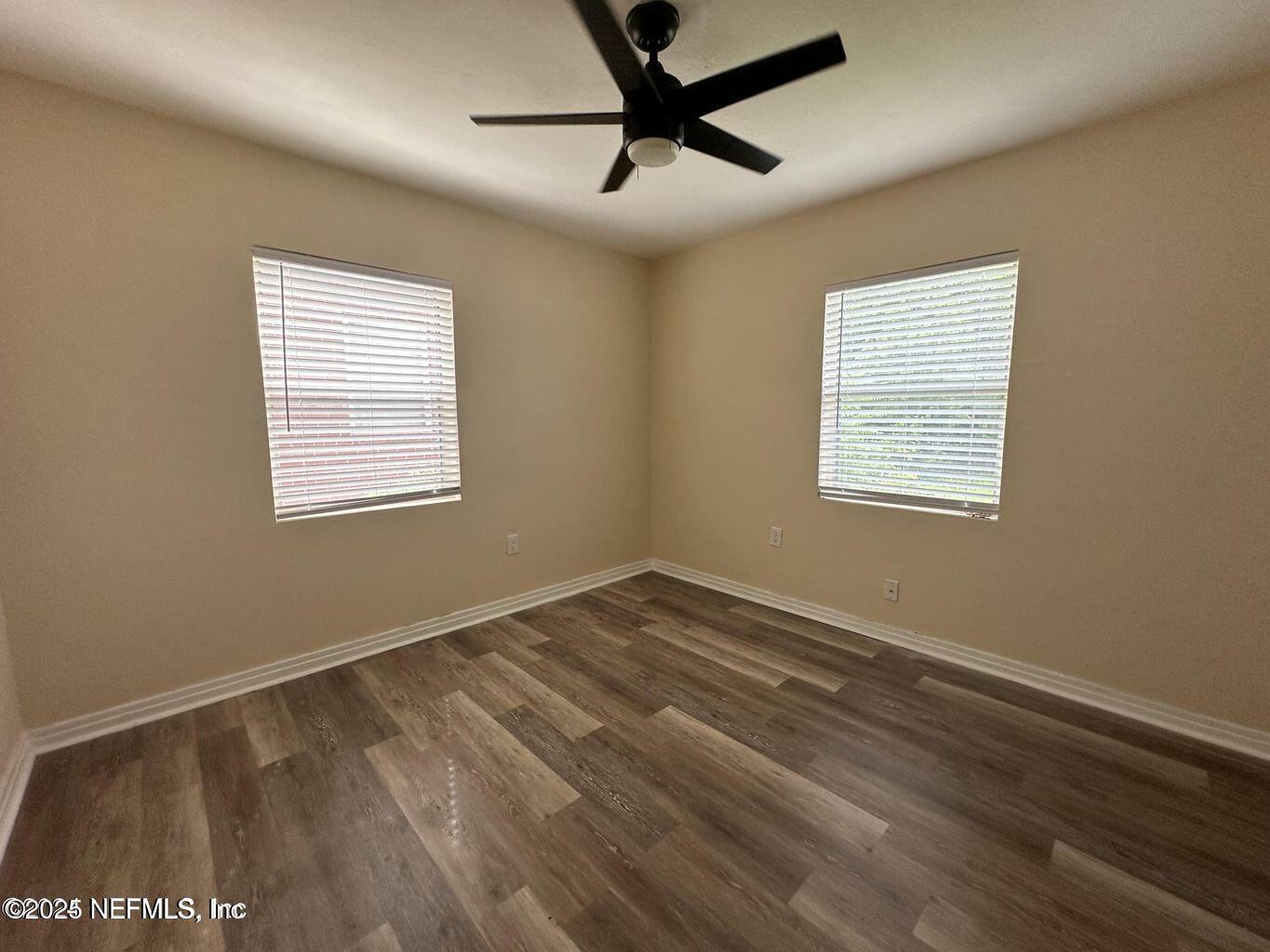 803 Crestwood Street Jacksonville, FL 32208 - Photo 10 of 14 a view of an empty room with a window and wooden floor