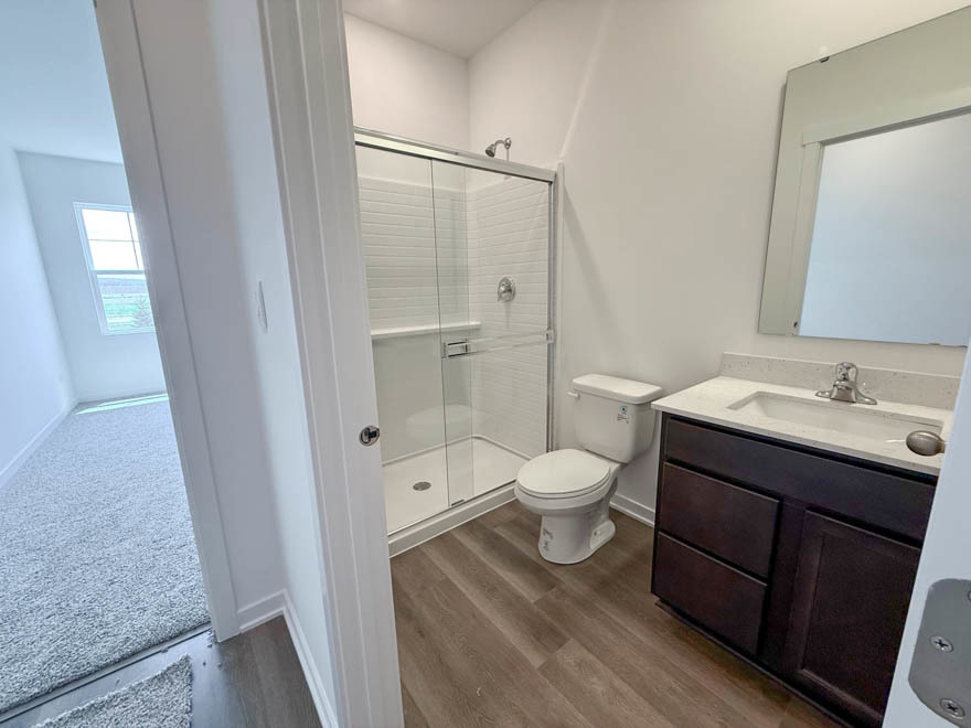 2459 Scribe Street Oswego, IL 60543 - Photo 9 of 27 a bathroom with a sink a toilet and shower