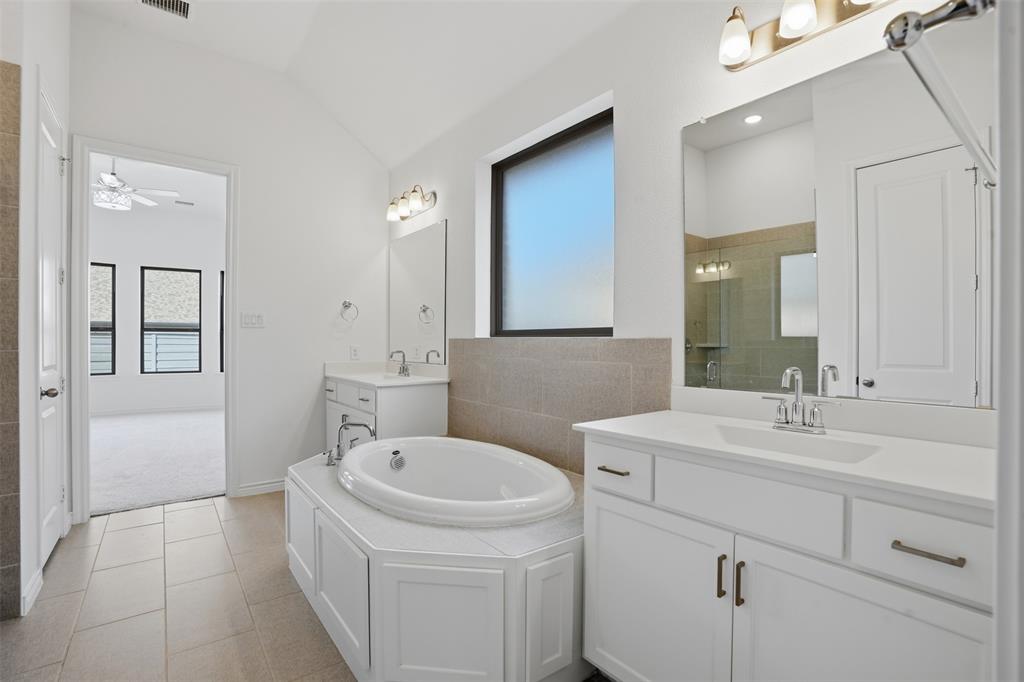 537 Oakmoss Street Little Elm, TX 76227 - Photo 16 of 39 a bathroom with a sink a toilet and mirror