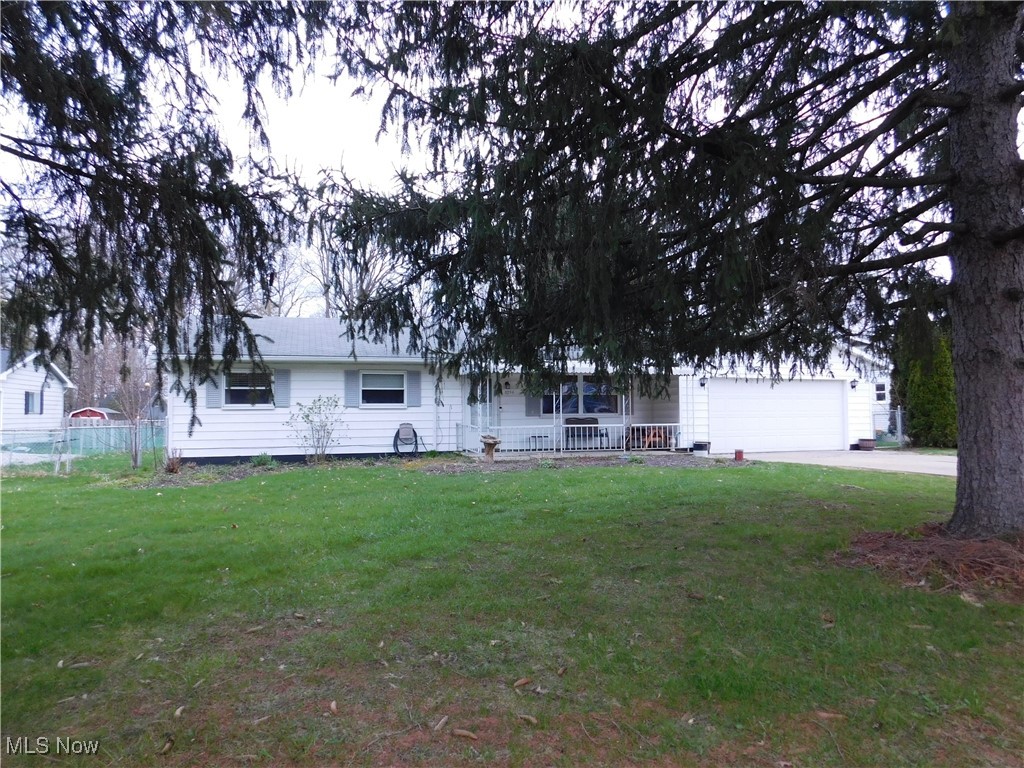 8754 Root Road North Ridgeville, OH 44039 - Photo 39 of 39 Single story home with a porch, a front lawn, an attached garage, and concrete driveway