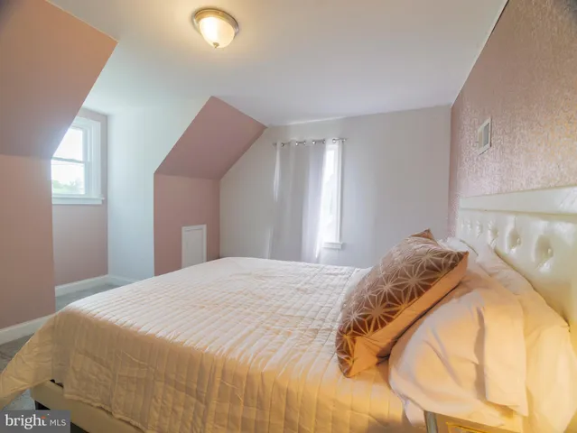 a bedroom with a bed and a lamp