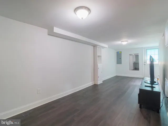 a view of a room with wooden floor