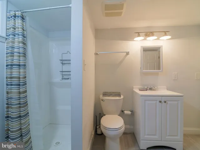 a bathroom with a toilet a sink and shower