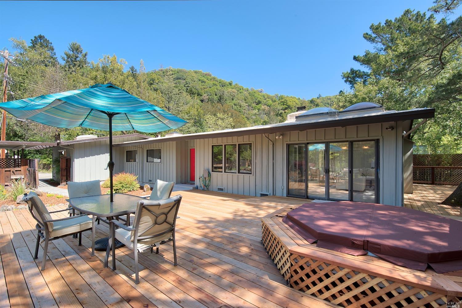 a view of a house with backyard sitting area and garden