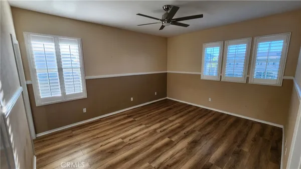 a view of a room with wooden floor and windows