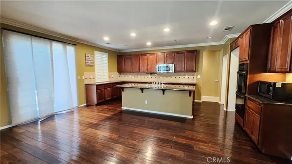 a kitchen with stainless steel appliances granite countertop a stove a sink dishwasher and a refrigerator