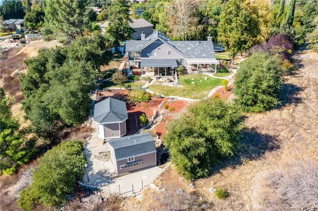 a view of house with yard and sitting area