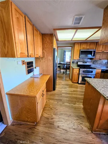 a kitchen with stainless steel appliances granite countertop a stove sink and microwave