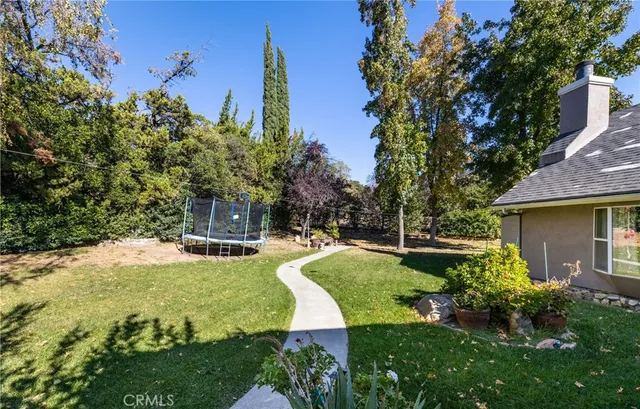 a view of a house with garden and sitting area
