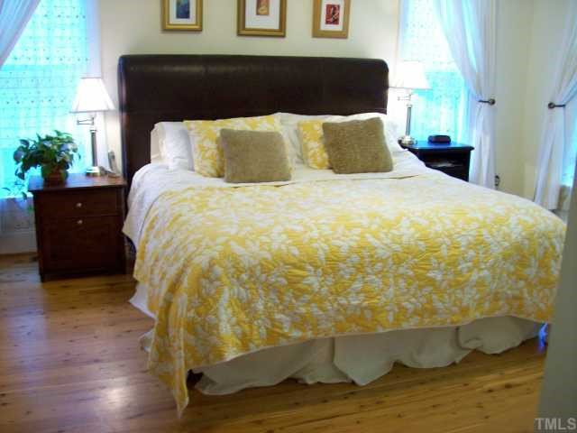 8204 Dreamy Way Raleigh, NC 27613 - Photo 6 of 12 Large first floor Master bedroom with hardwoods will easliy handle this king bed...also features a lighted tray ceiling Master Bedroom