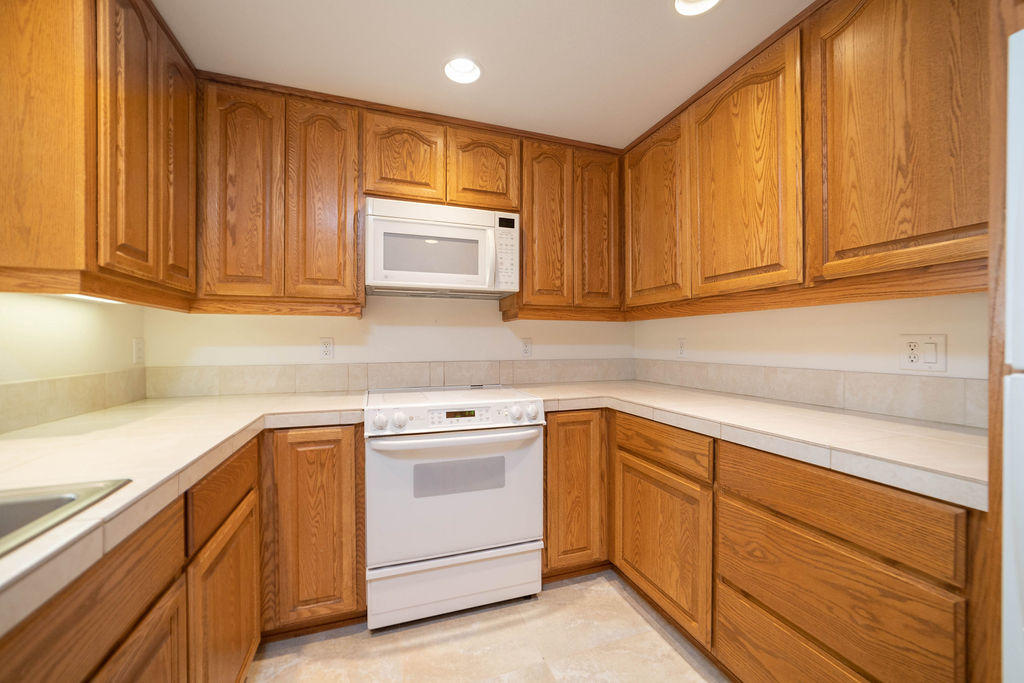 16944 Downey Road Bend, OR 97707 - Photo 10 of 44 a kitchen with cabinets appliances a sink and a window