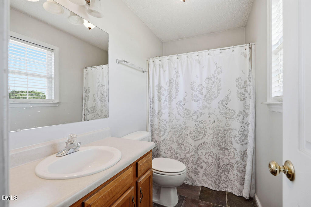 1560 Cane Mill Road Coats, NC 27521 - Photo 24 of 32 a bathroom with a sink and a mirror