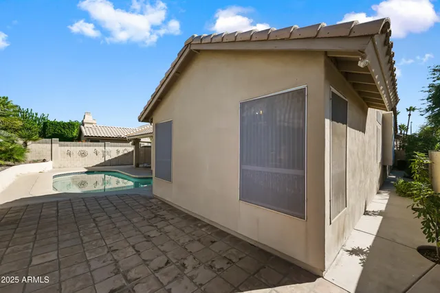 a room with lots of white furniture and a painting on the wall