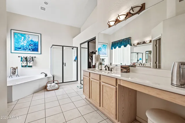 a bathroom with a granite countertop sink a mirror and a shower