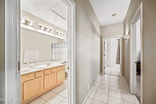 a living room with furniture and floor to ceiling windows
