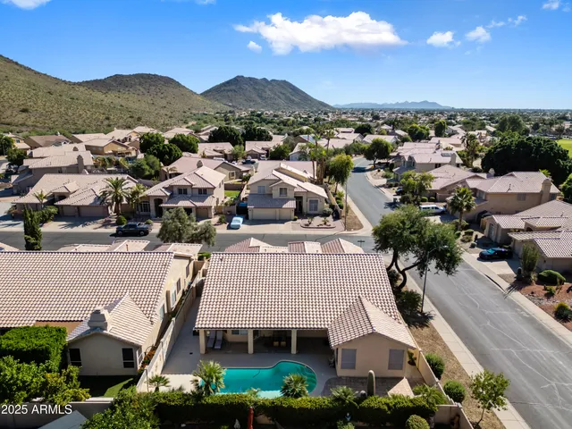 a living room with furniture a large window and a flat screen tv