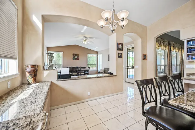 a kitchen with stainless steel appliances kitchen island granite countertop a sink and cabinets