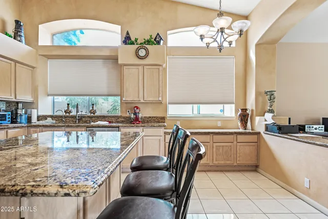 a kitchen with sink a window and cabinets