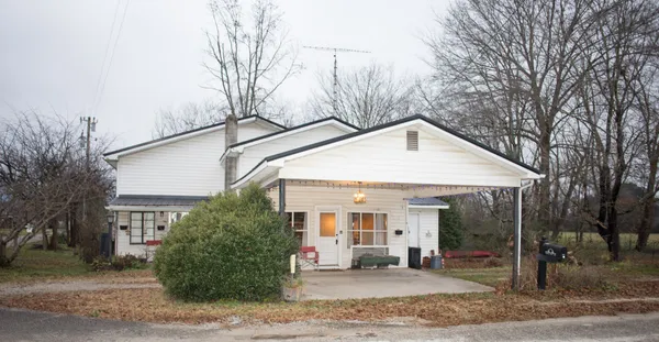 a view of a house with a yard and garage