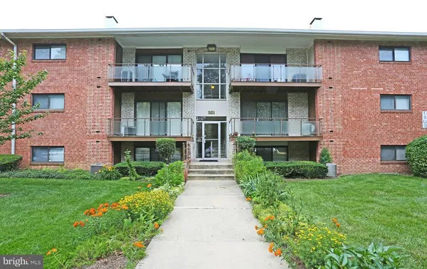 a front view of a brick house with a yard
