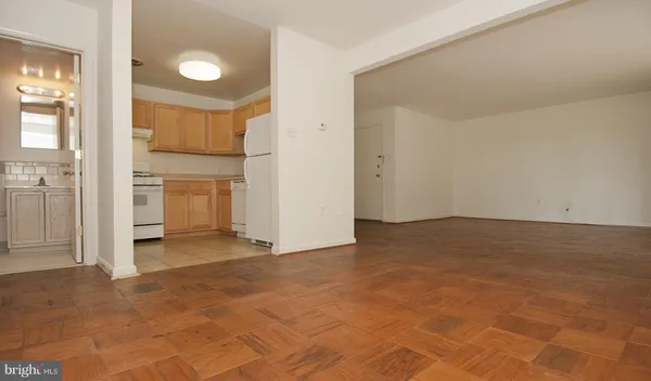 an empty room with a kitchen
