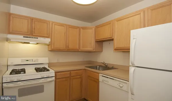 a kitchen with a white cabinets and white appliances