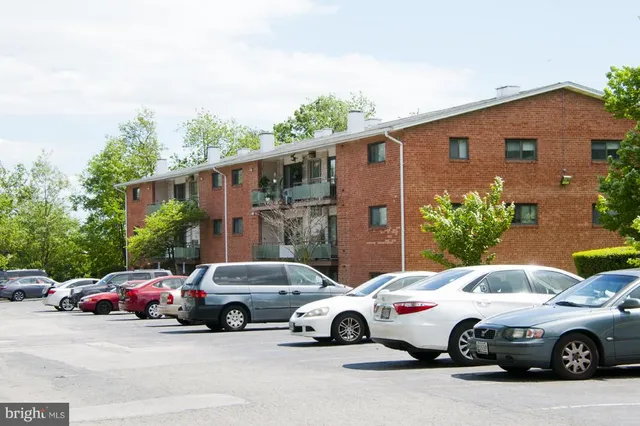 a front view of a house with a garden and plants