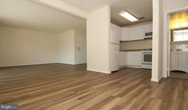 a view of a kitchen with wooden floor and a sink