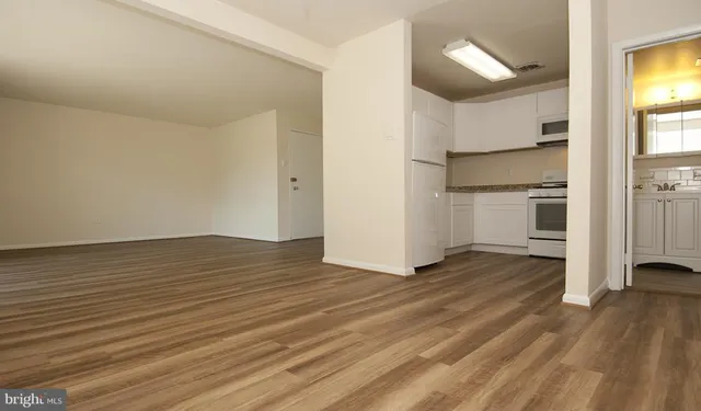 a view of a kitchen with wooden floor and a sink