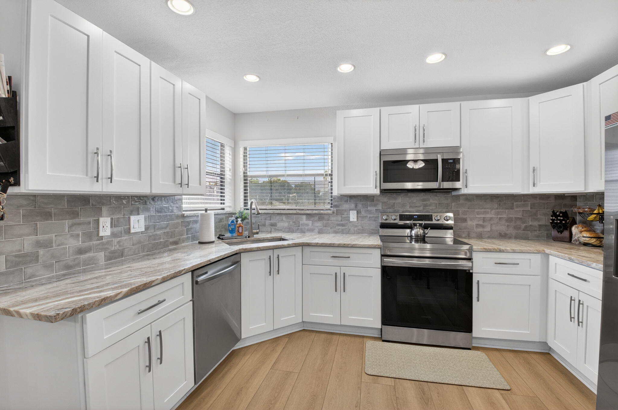 2360 Northwest 12th Street Delray Beach, FL 33445 - Photo 13 of 62 a kitchen with stainless steel appliances granite countertop a sink and cabinets
