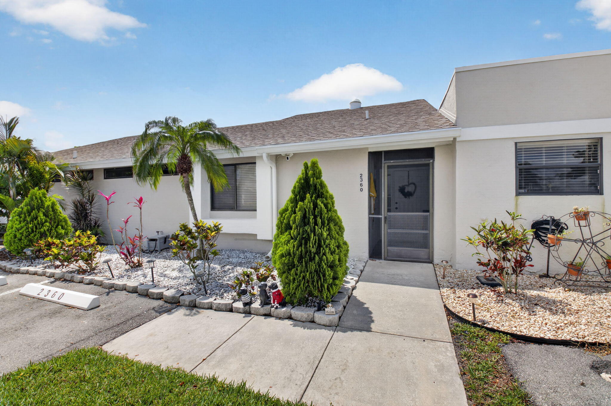 2360 Northwest 12th Street Delray Beach, FL 33445 - Photo 3 of 62 a front view of a house with garden