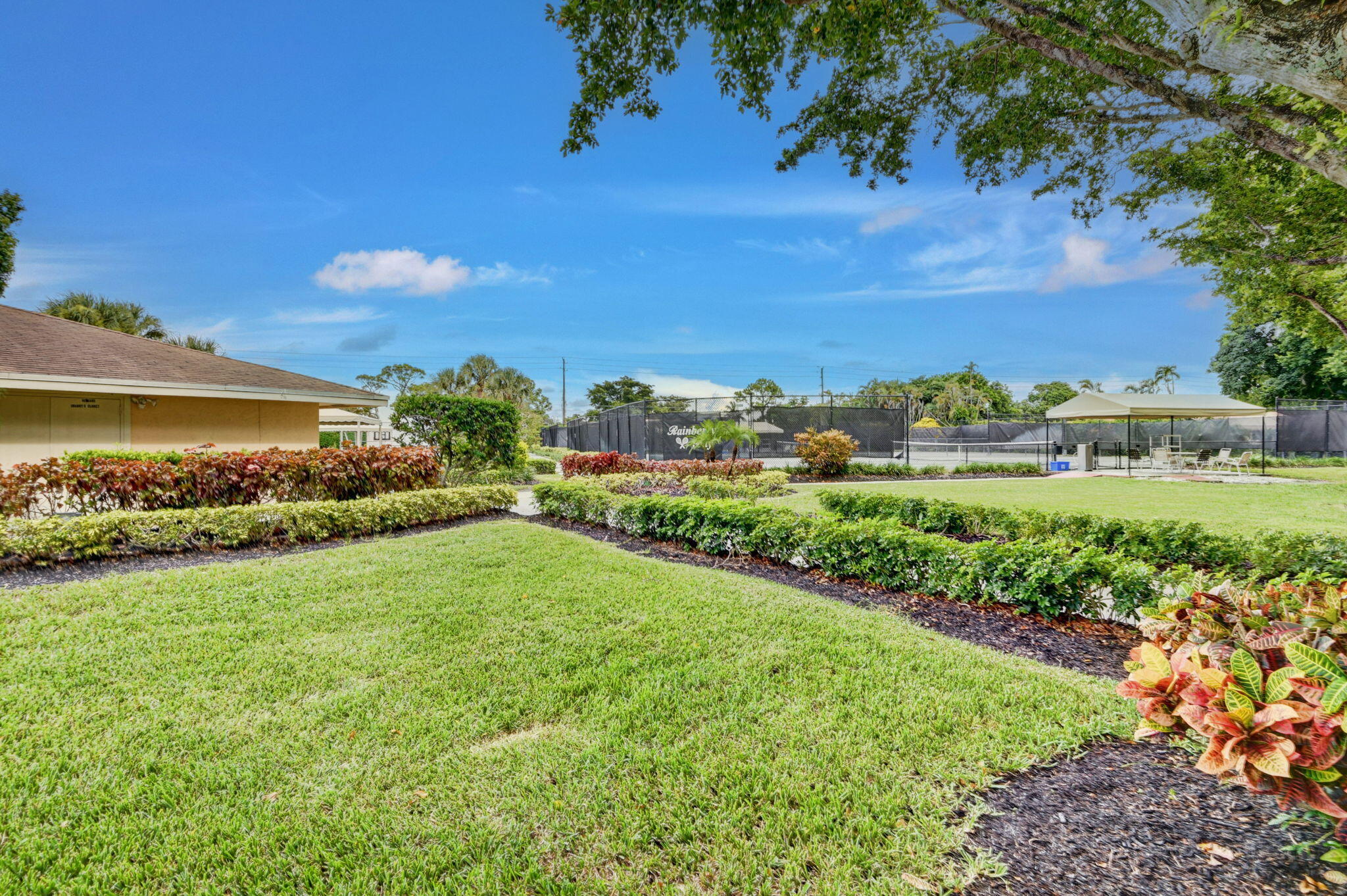 2360 Northwest 12th Street Delray Beach, FL 33445 - Photo 60 of 62 a view of a garden with a building in the background