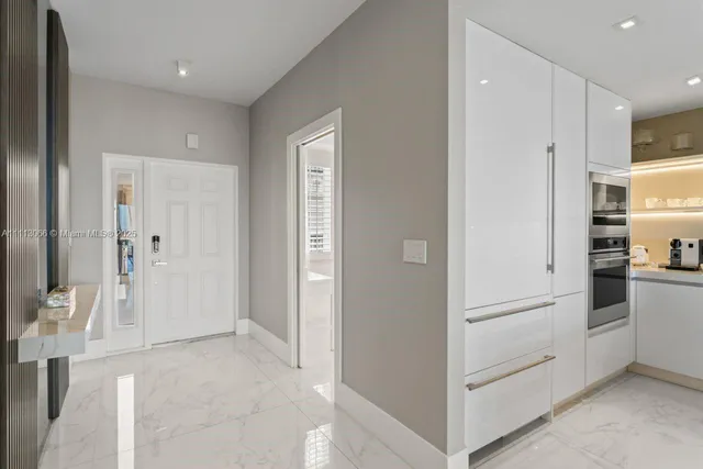 a living room with furniture potted plant and a large window