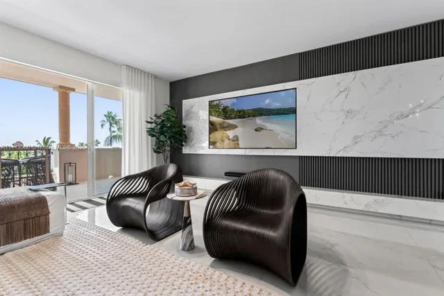 a living room with patio furniture and a potted plant