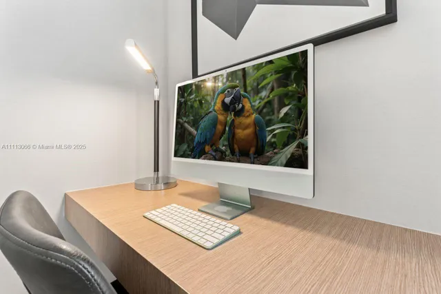 a view of a hallway with dining table and chairs