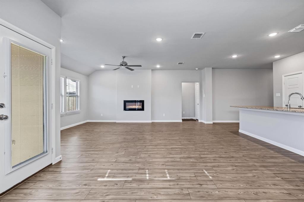 620 Shade Tree Way Princeton, TX 75407 - Photo 14 of 35 a view of an empty room with wooden floor and a window