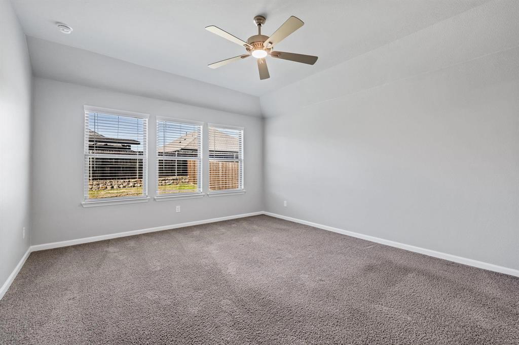 620 Shade Tree Way Princeton, TX 75407 - Photo 17 of 35 a view of an empty room with a window and a ceiling fan